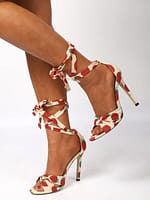 a woman's legs in a pair of Fruit Print Tie Leg Stiletto Sandals by Stiletto Sandals