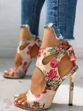 a woman's feet in a pair of Allover Floral Ankle Strap Sandals from the brand Allover Floral Ankle Strap Sandals