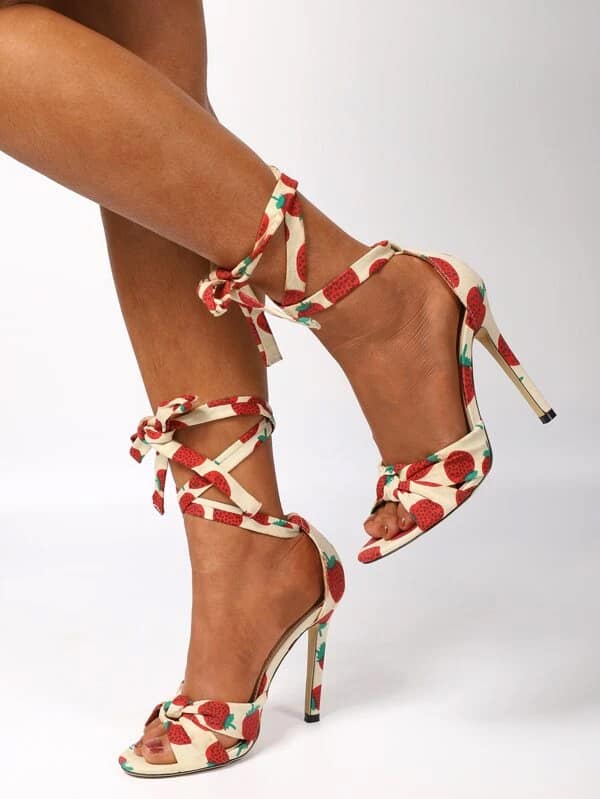 a woman's legs in a pair of Fruit Print Tie Leg Stiletto Sandals by Stiletto Sandals
